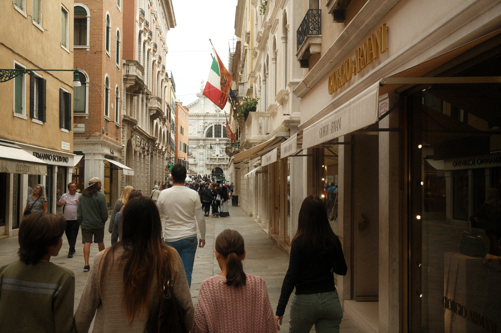 A street lined with designer shops, facing towards the Chiesa Parrocchiale di San Moisè