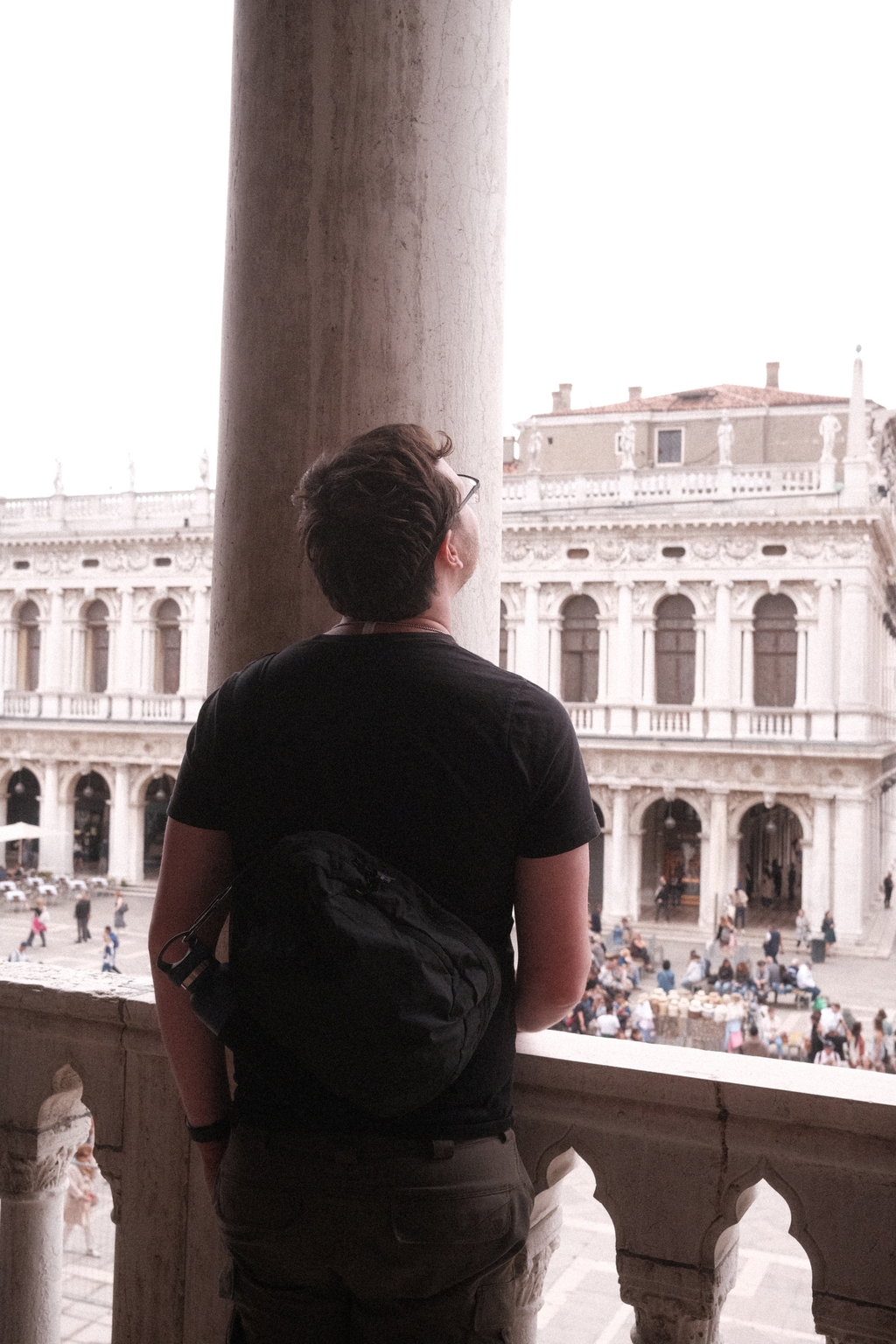 Nick standing between the red marble pillars, where the Doge would address the people of Venice