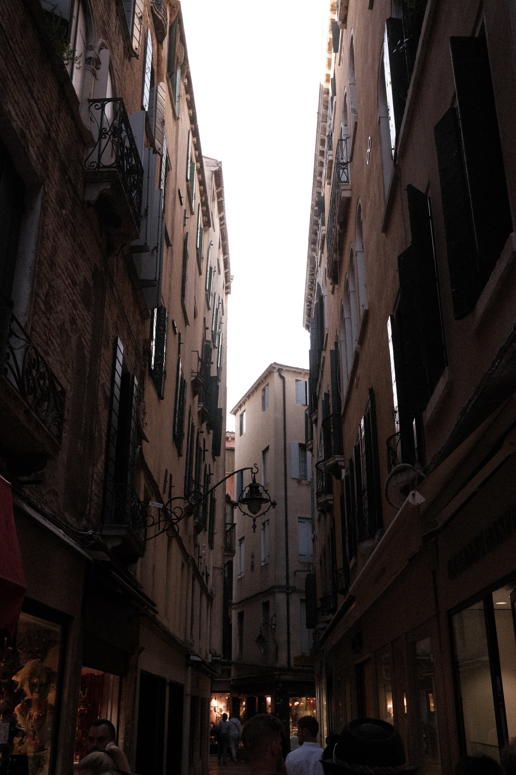 A narrow street in Venice near sunset