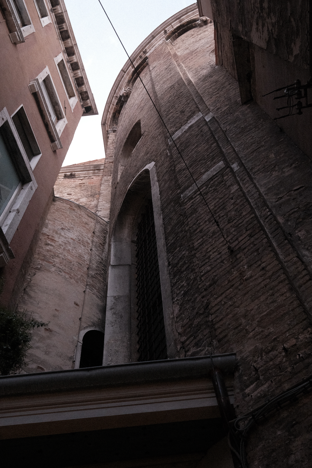 Looking up a narrow street towards a stone turret