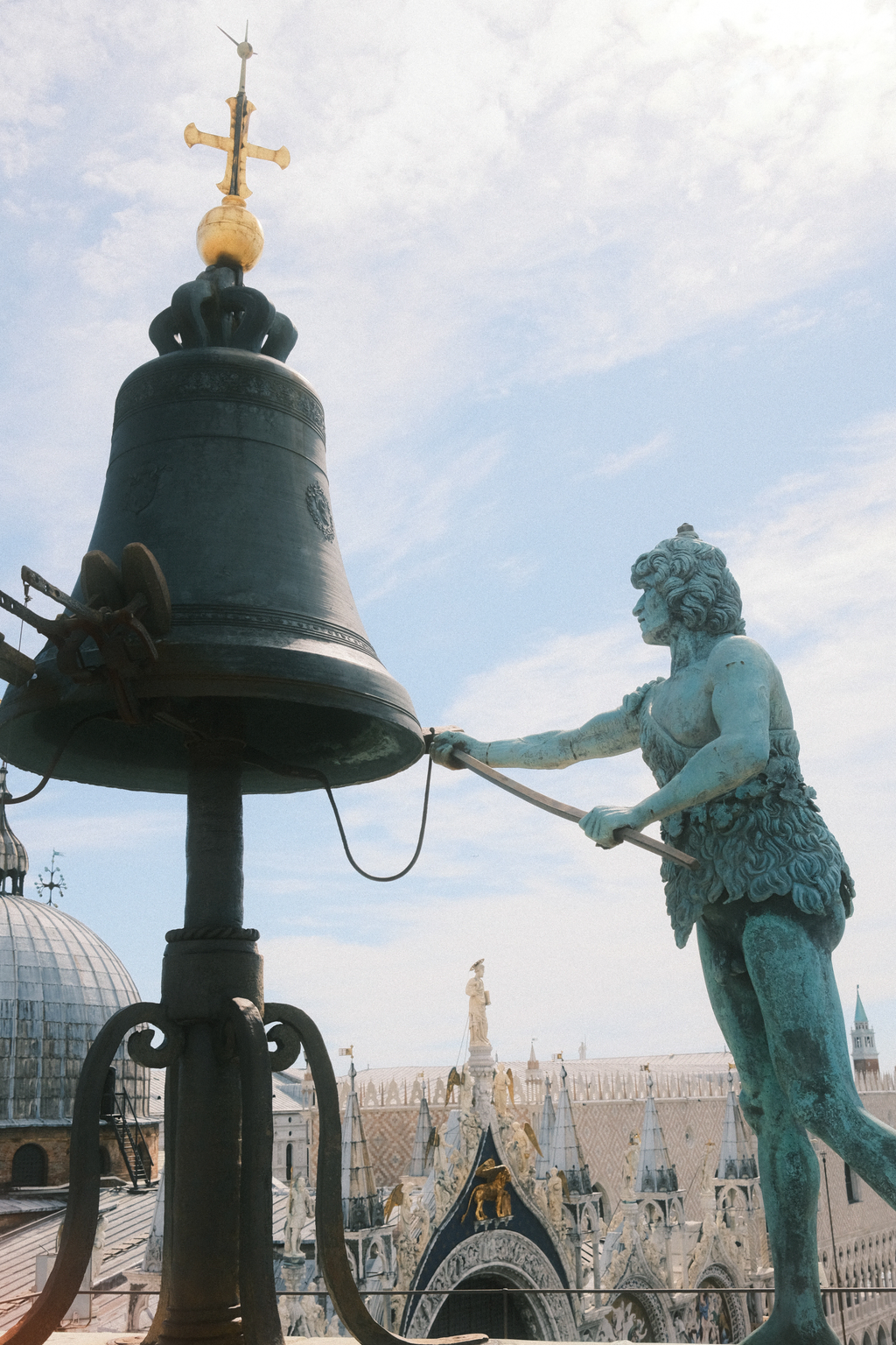 Statues of "the present" which strikes the clock tower's bell on the hour