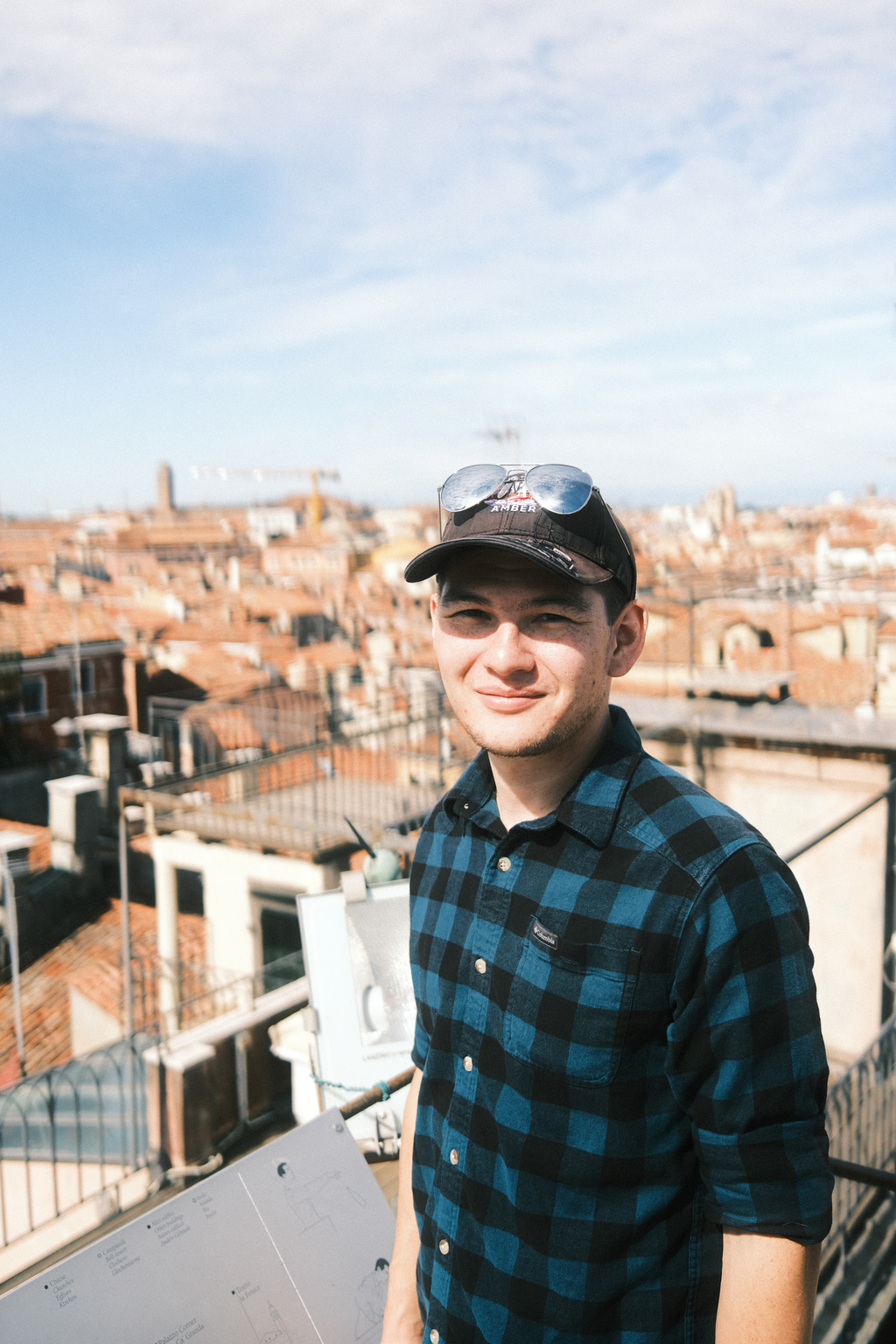 Tim on the balcony of the clock tower, overlooking rooftops of Venice