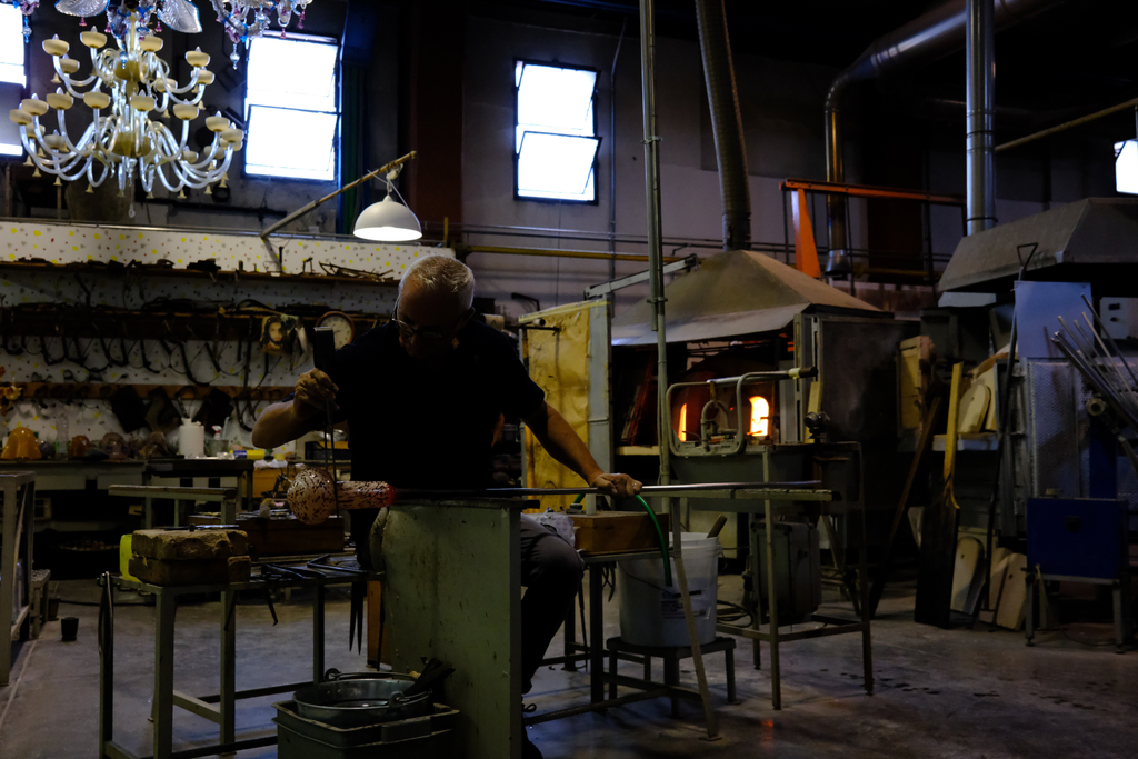 Glass blower forming the body of a pitcher