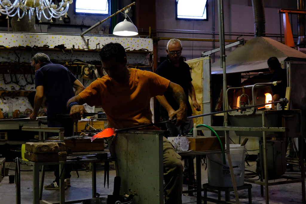 Glass blower begining to form a horse from a bead of molten glass