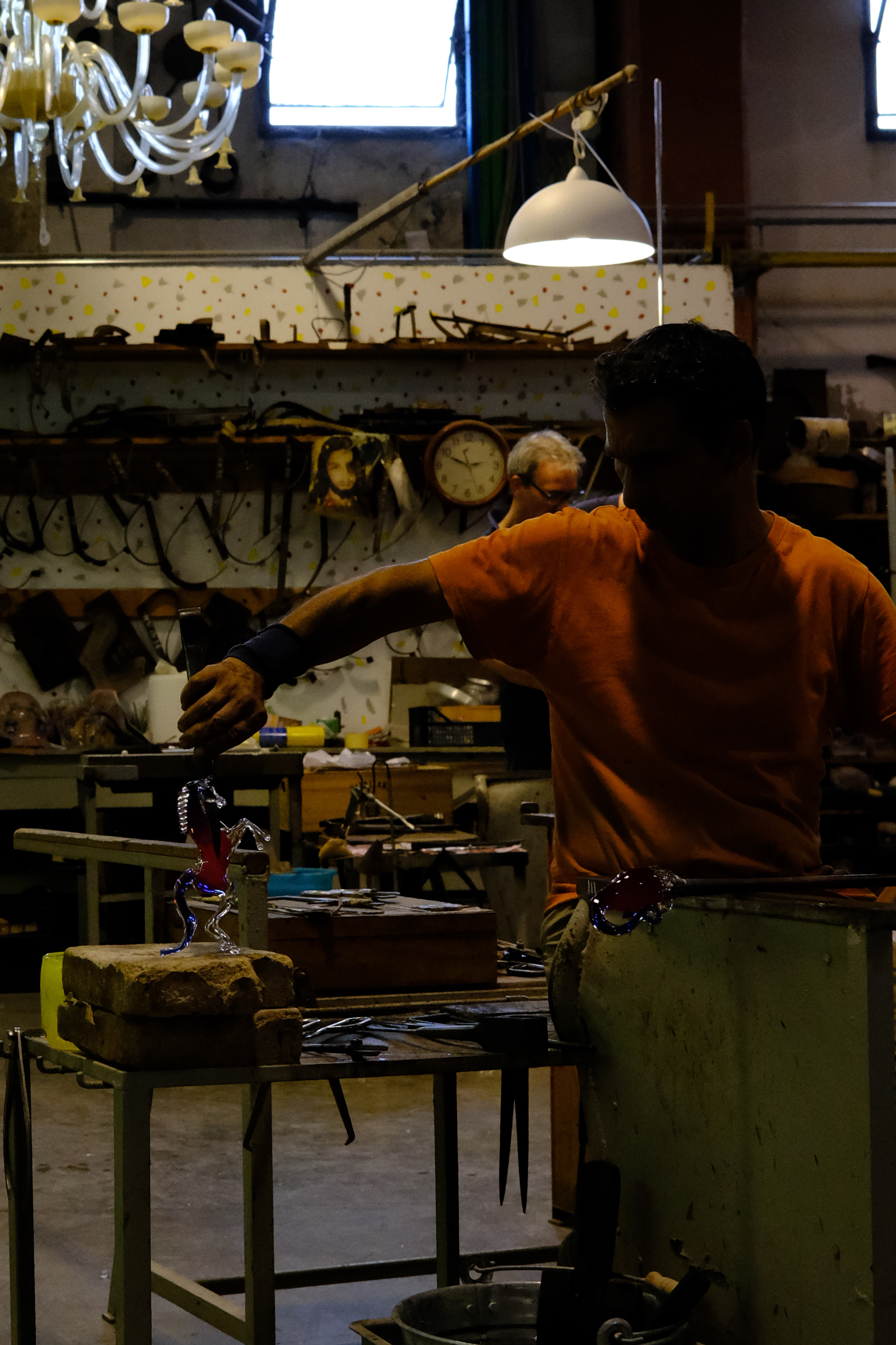 Glass blower finishing creating a glass-blown horse