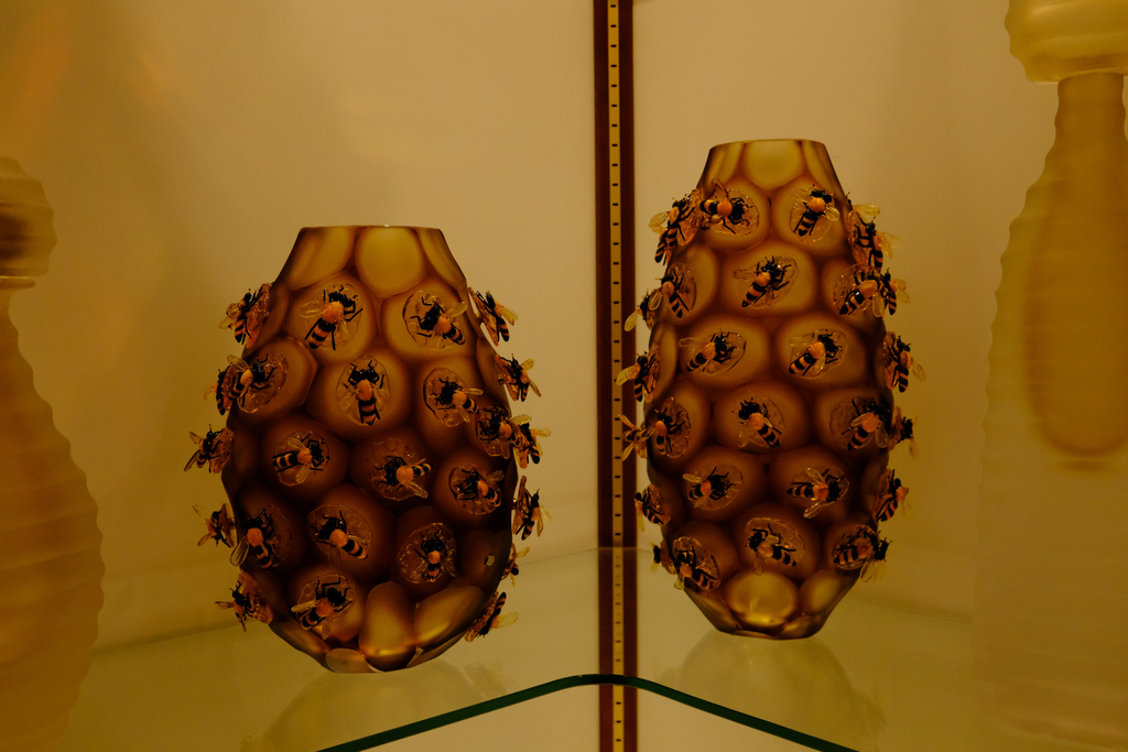 Glass vases in the style of honeycomb with glass bumblebees on each cell