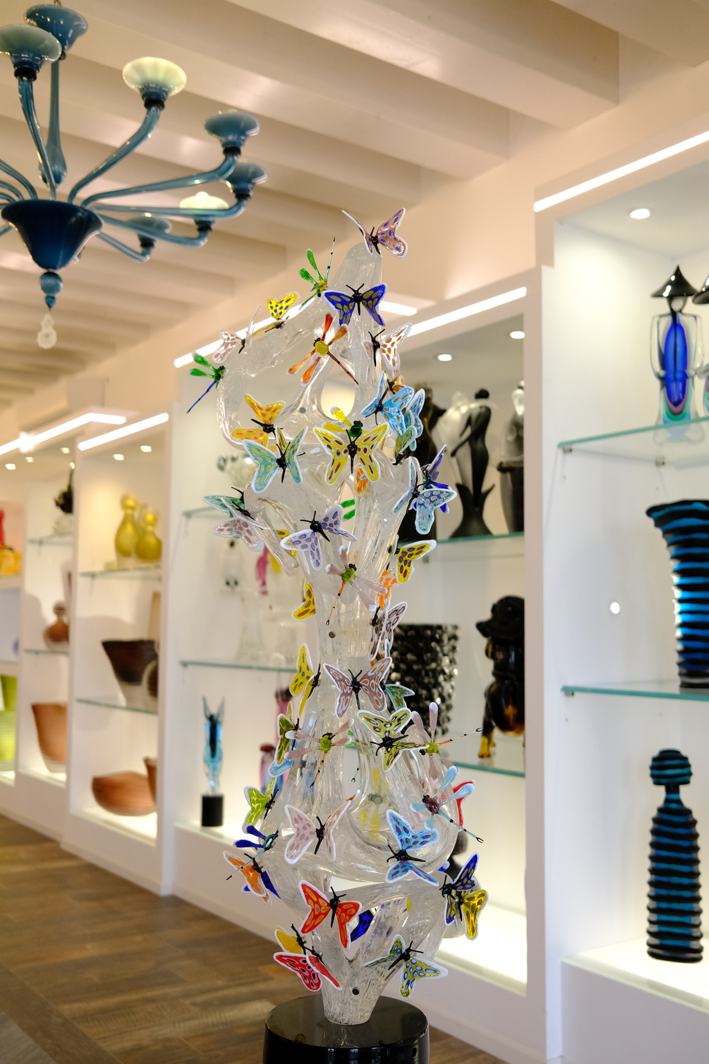 A glass sculpture covered in butterflies