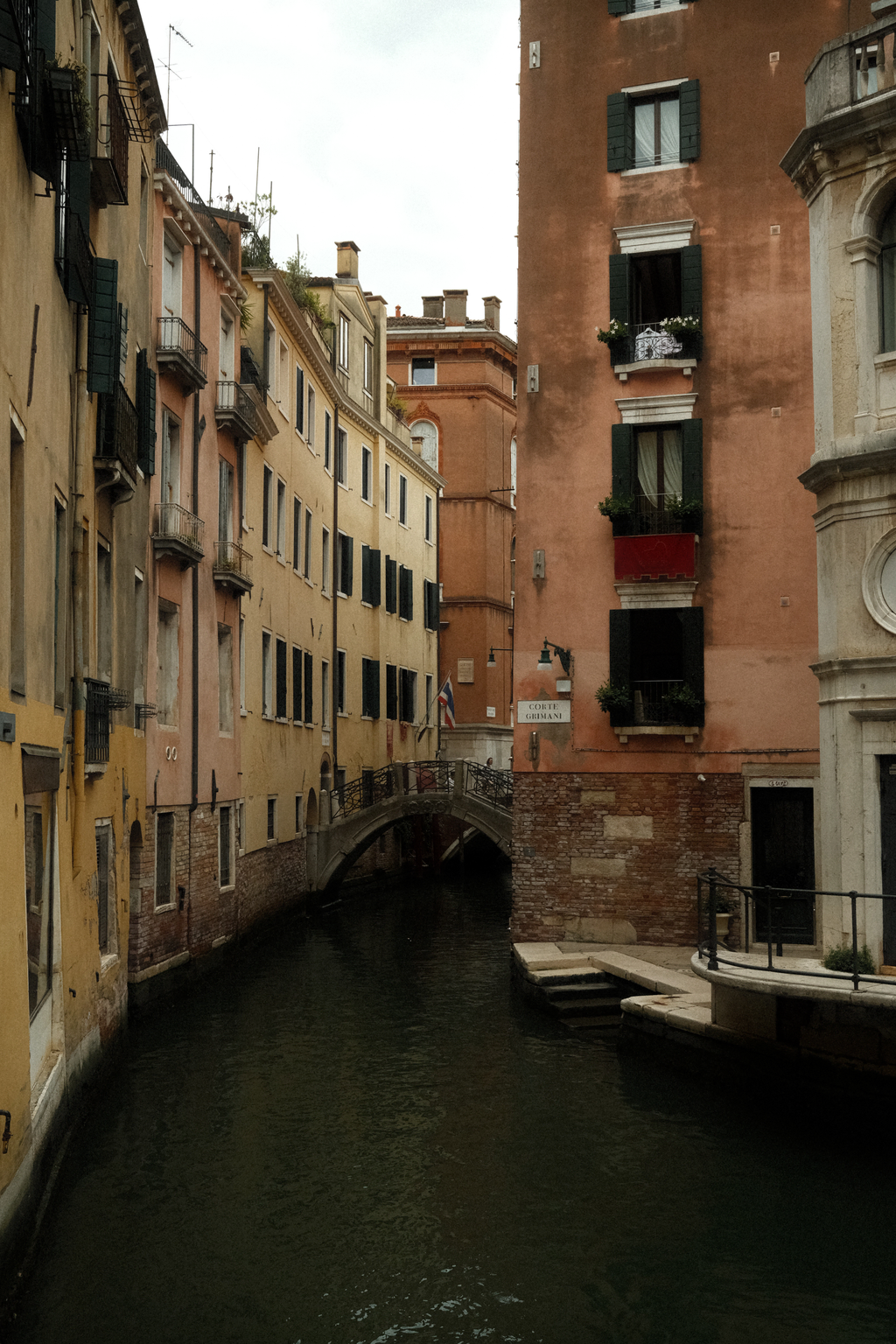 A quiet canal lined by colorful buildings