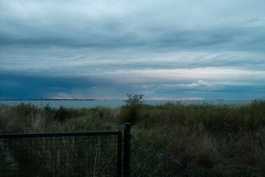 View off the southwest corner of Isola delle Rose of storms passing by