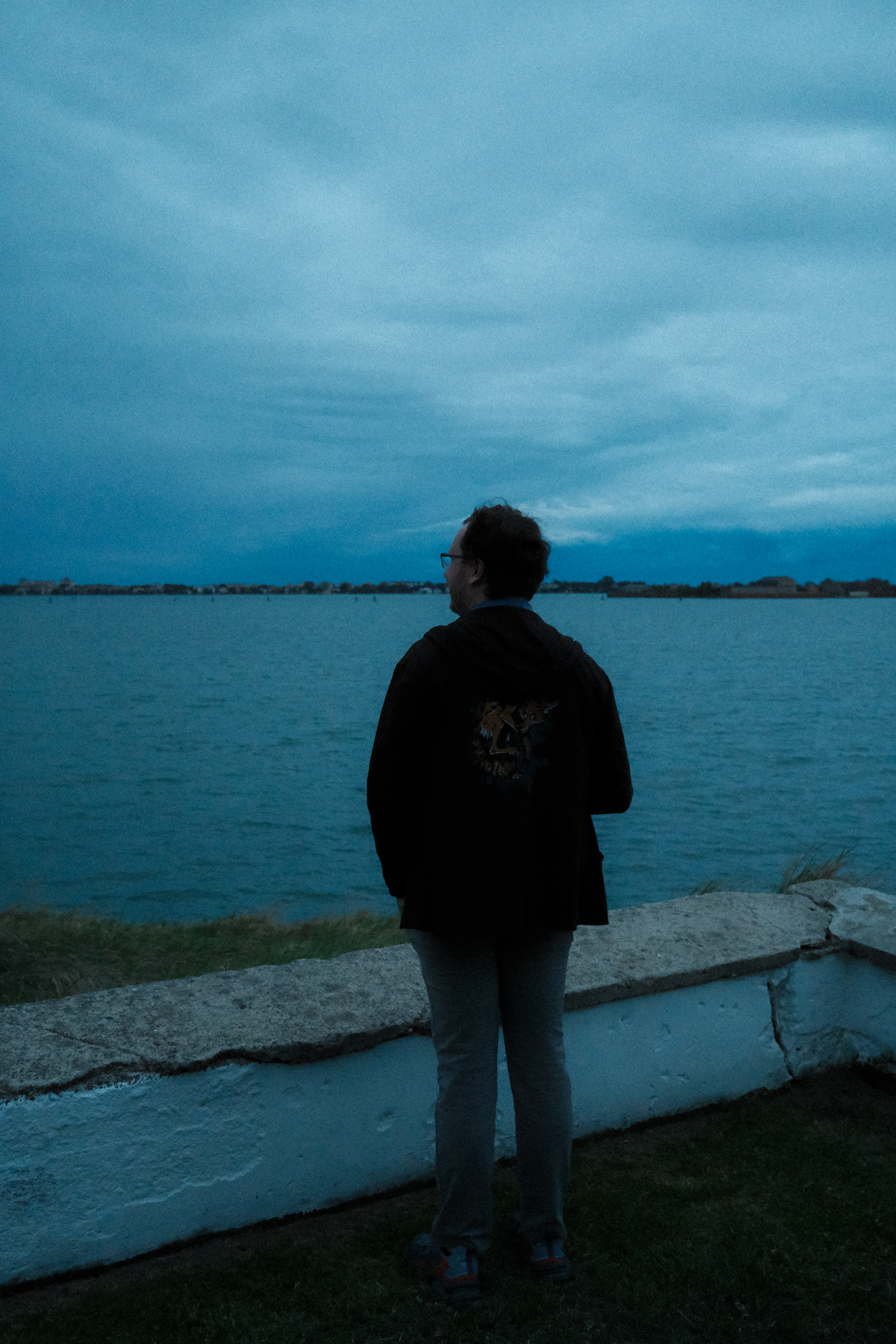 Nick standing on the south-east tip of the Isola delle Rose, facing Lido at dusk