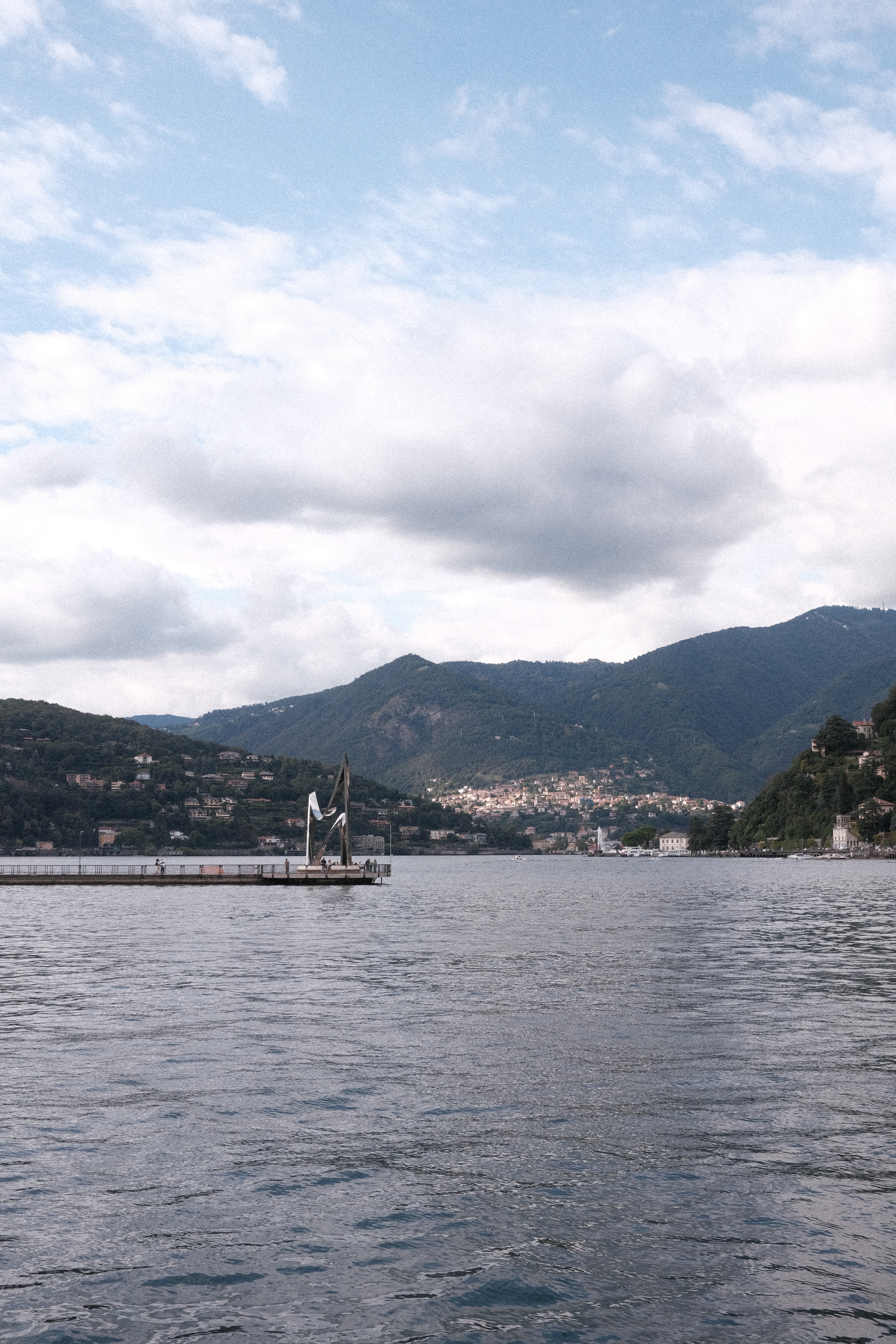 The statue "Life Electric" jutting out into Lake Como