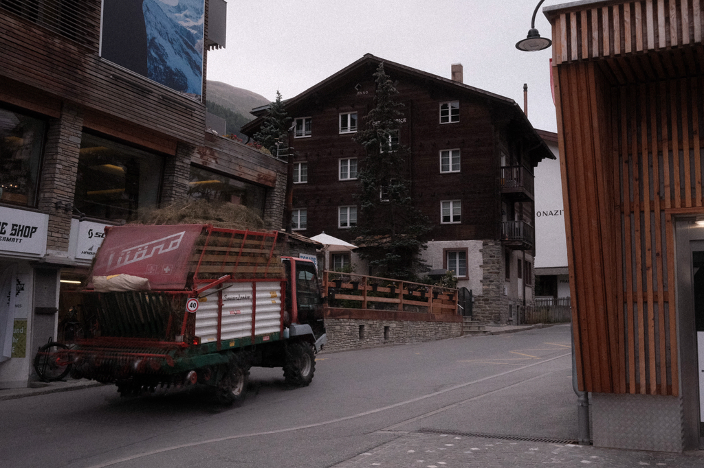 A farm utility truck rolling through the streets