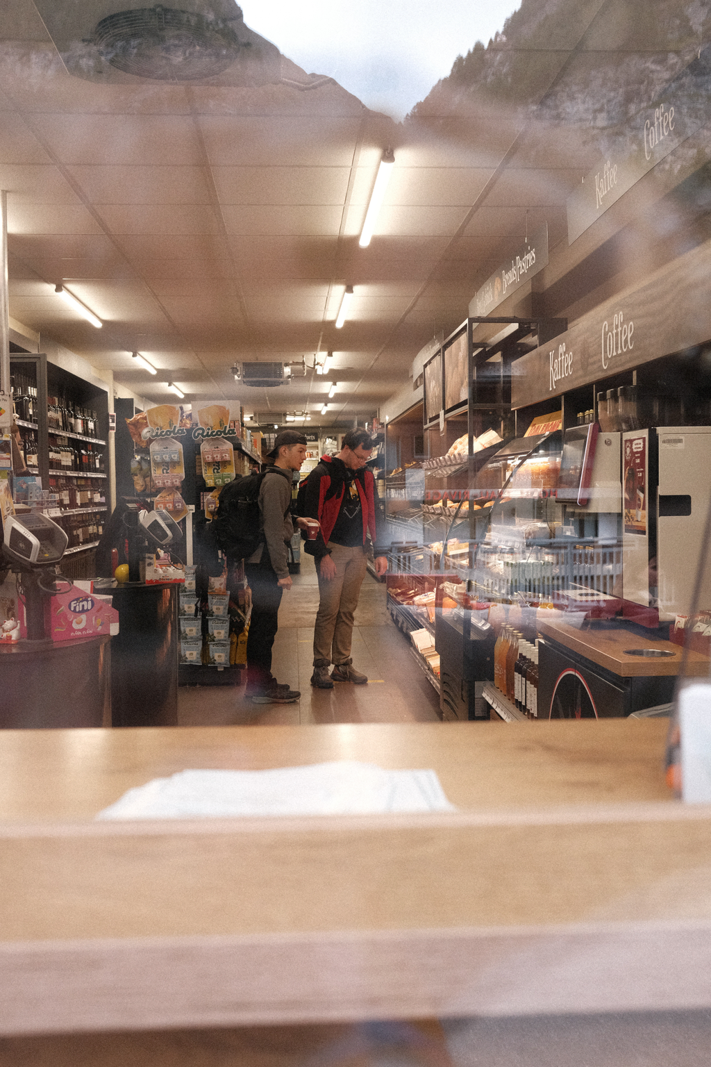 Nick & Tim shopping in Edelveiss Market with Sean in the reflection