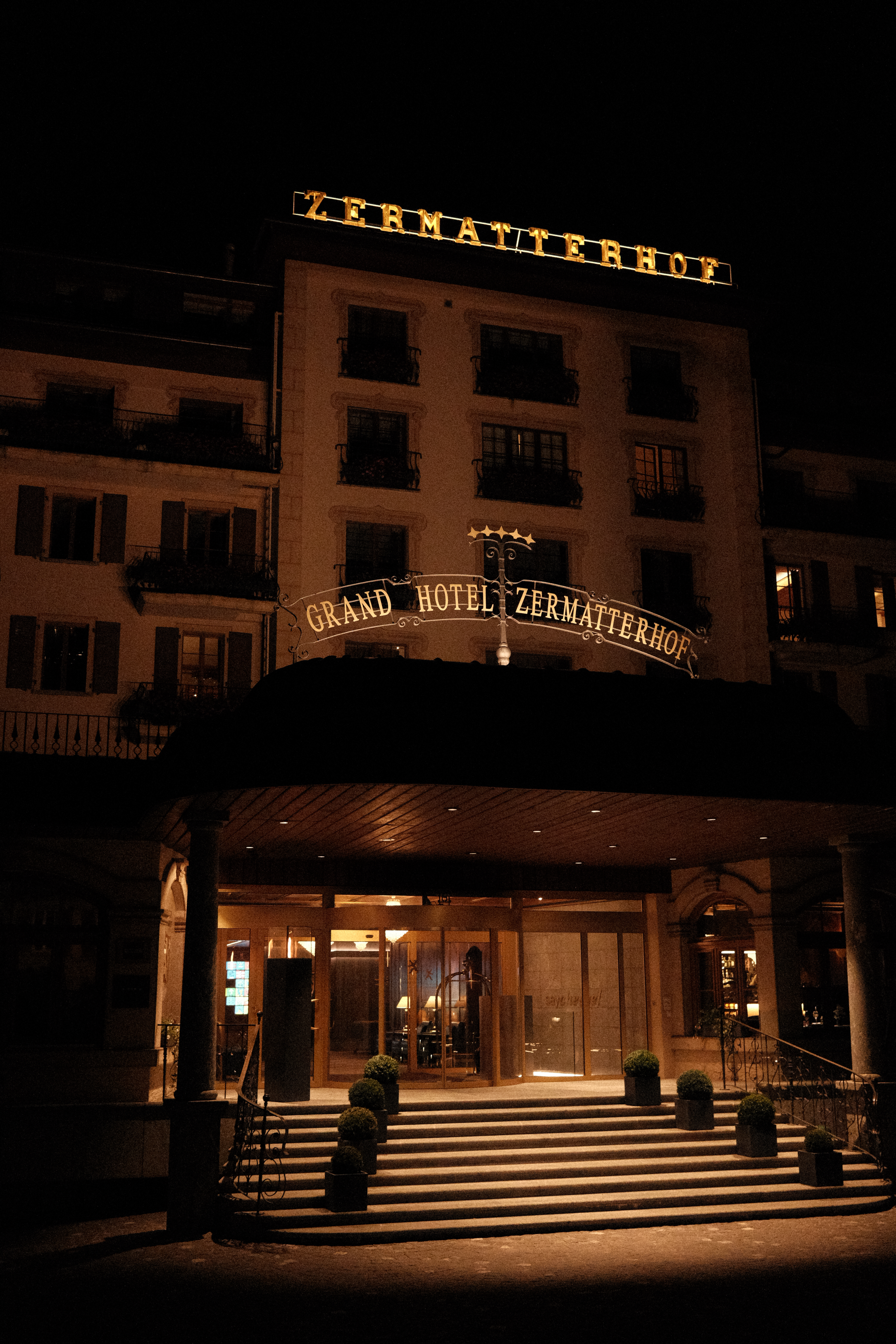 Grand Hotel Zermatterhof at night, highlighting the golden accents