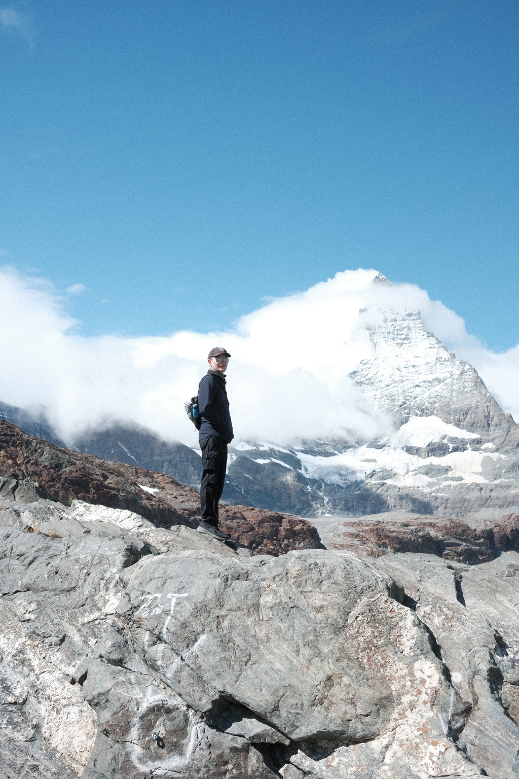 Tim on a rocky outcrop in front of the Matterhorn