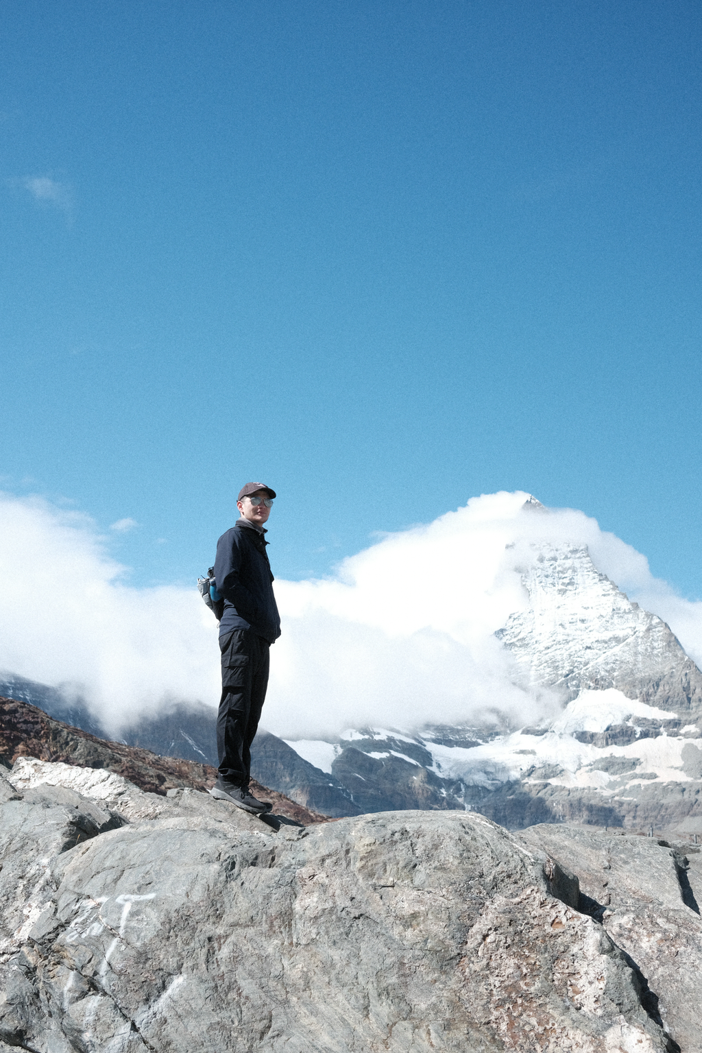 Tim on a rocky outcrop in front of the Matterhorn