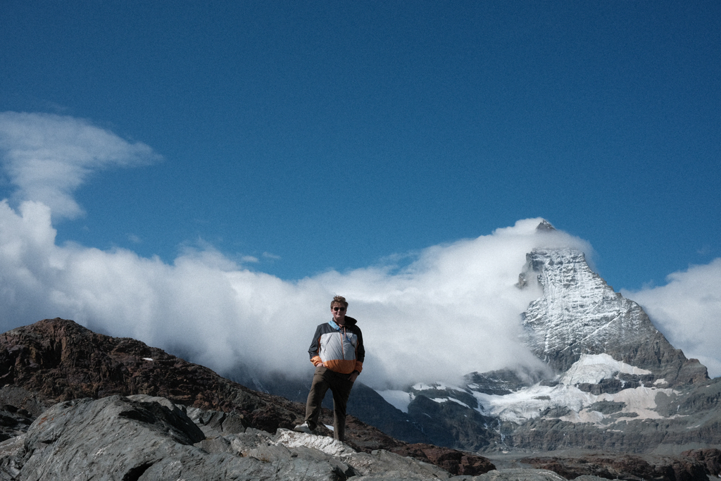 Sean on a rocky outcrop in front of the Matterhorn