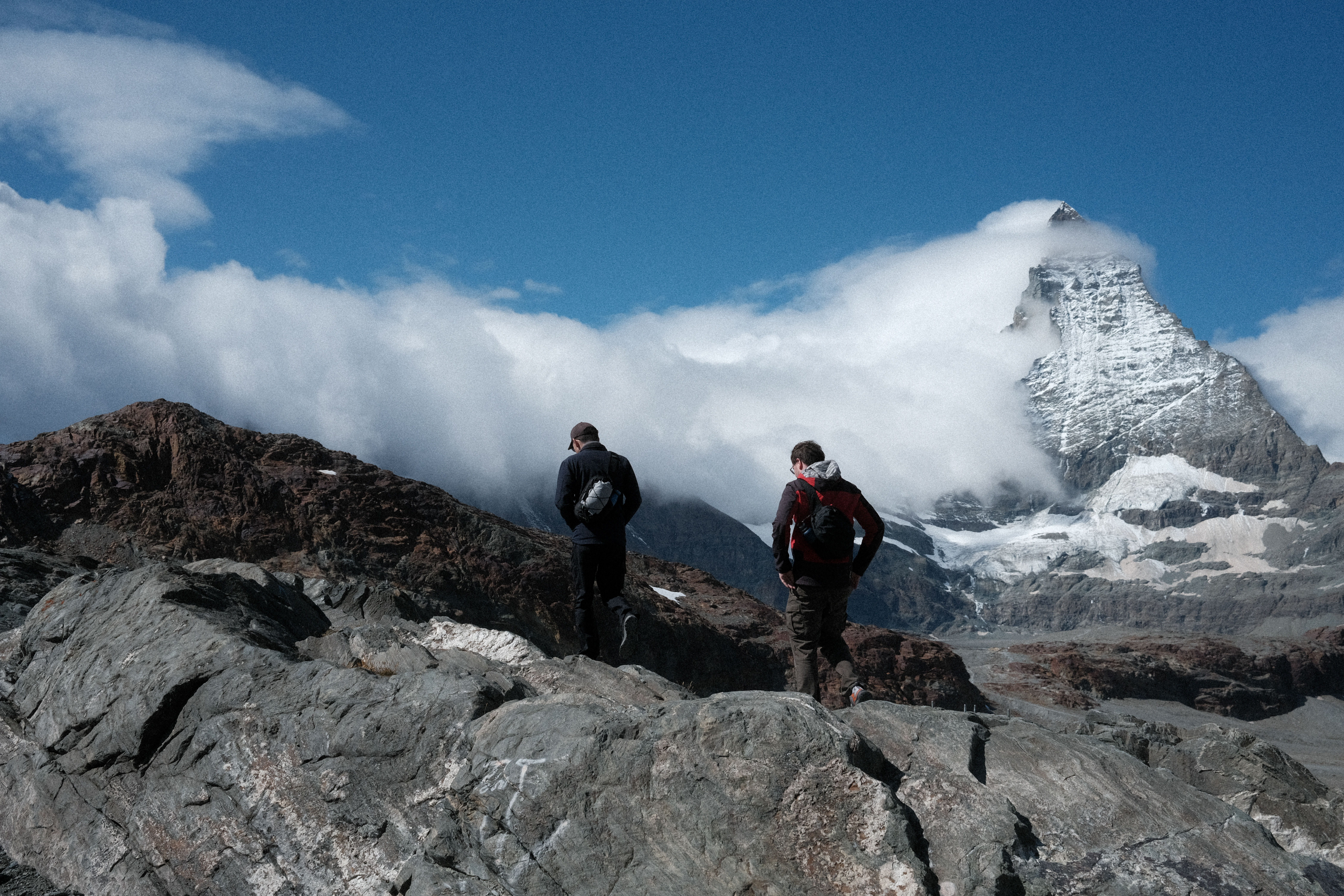 Nick & Tim climbing out on a rocky outcrop with the Matterhorn