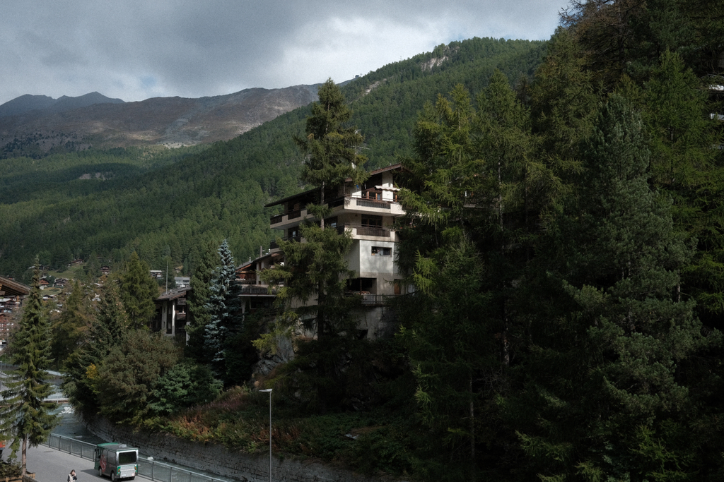 A building among the fir trees at the shore of Matter Vispa