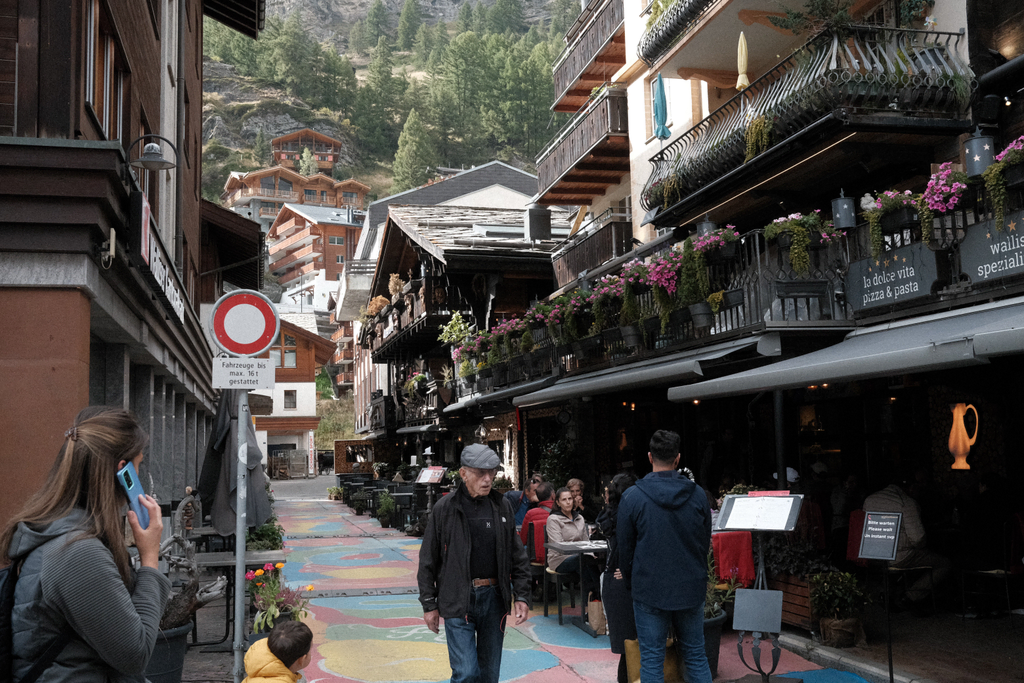 A colorful street looking up the valley at several homes