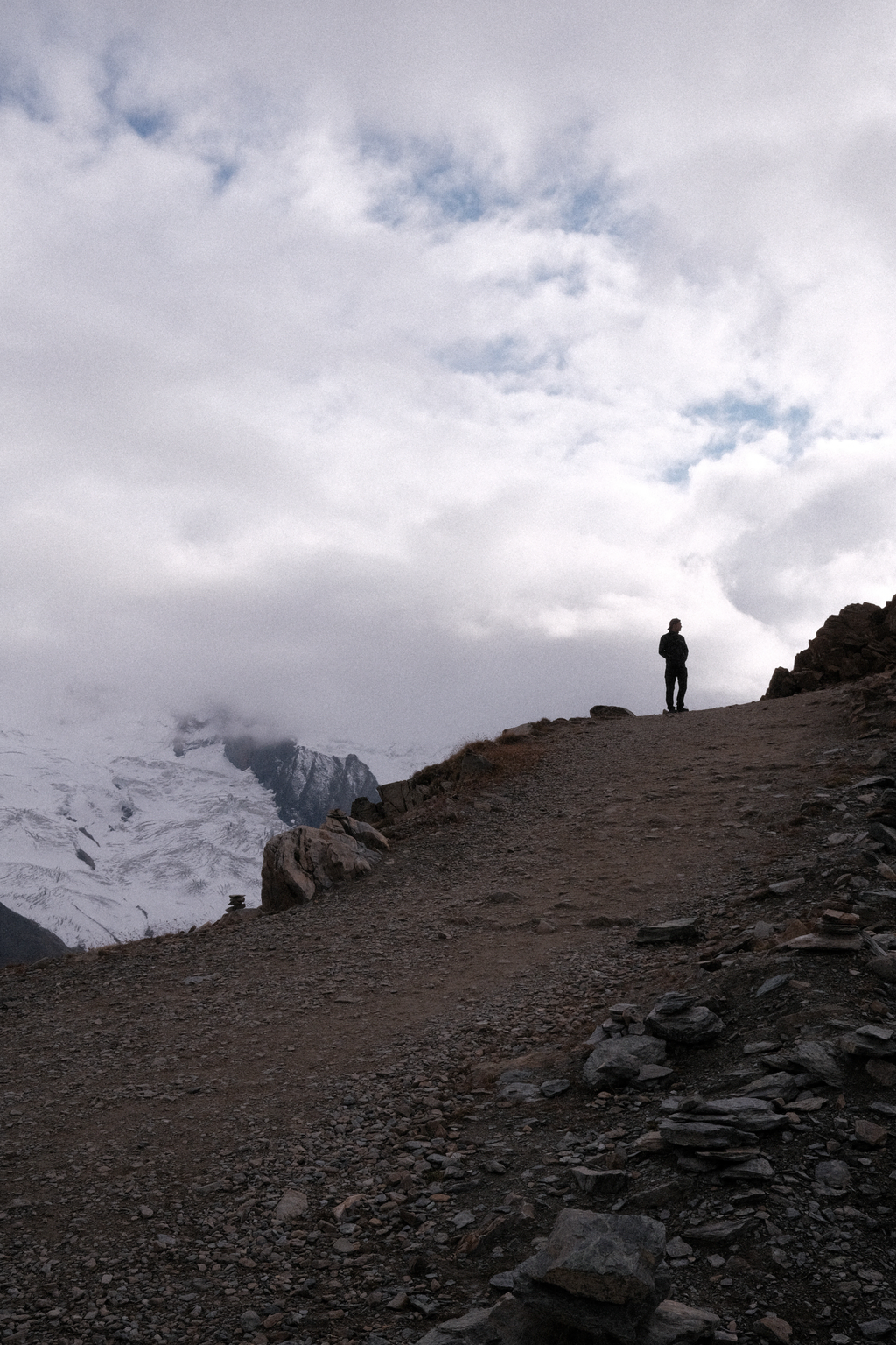 Tim silhouetted against the sky with Monte Rosa glacier in the background