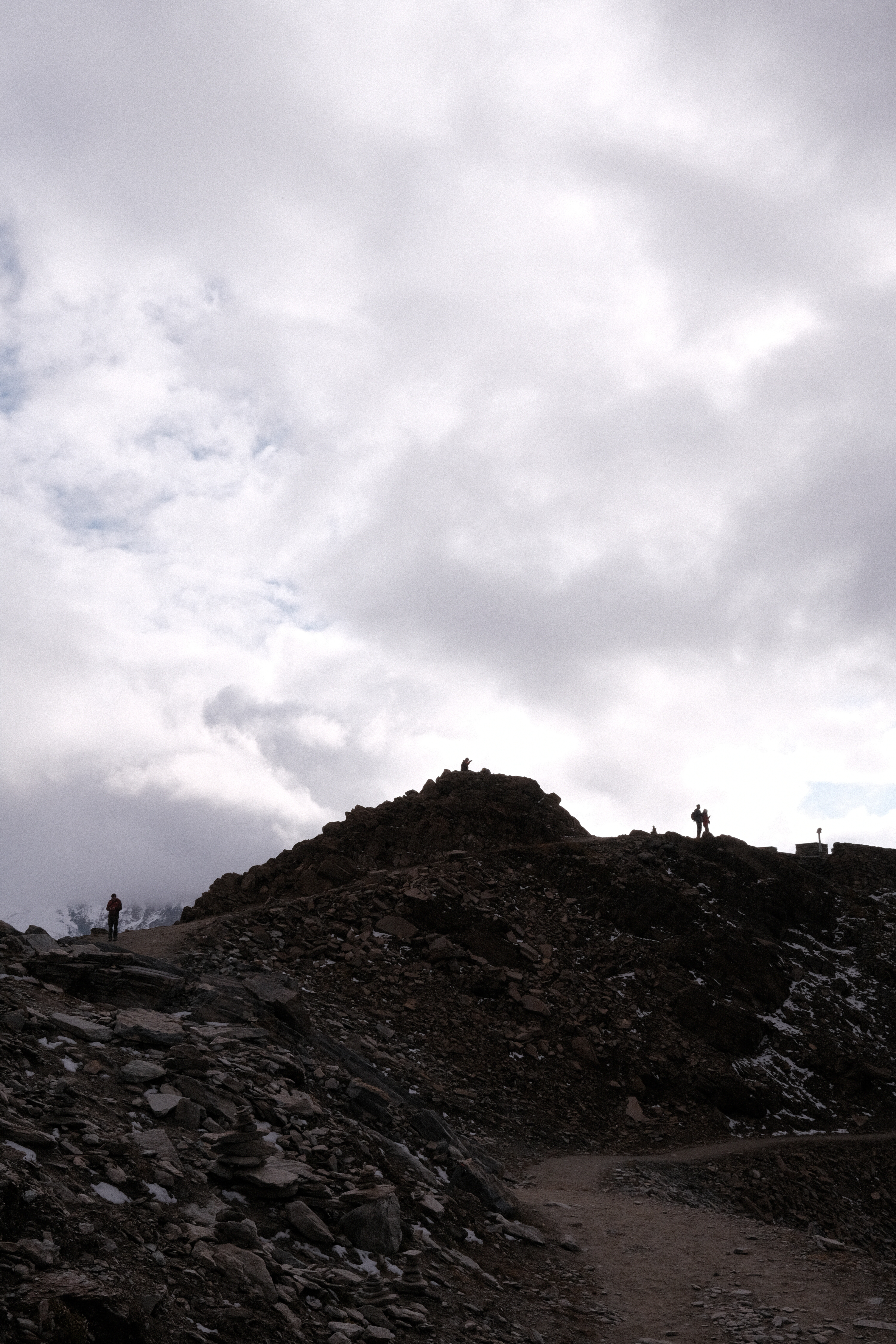 Various silhouettes against the rough, rocky skyline