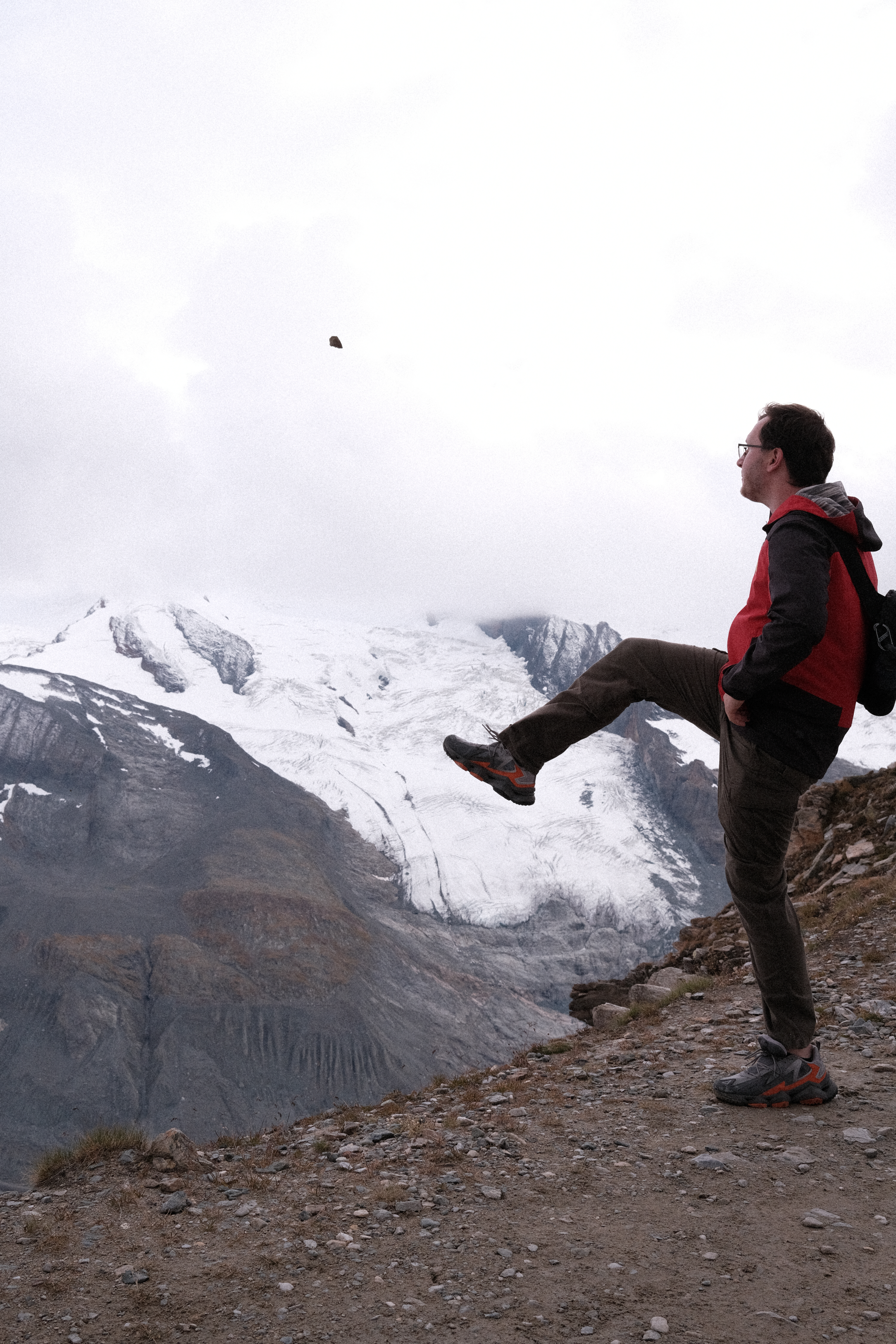 Nick kicking a rock off the step side of the mountain, towards Monte Rosa Glacier