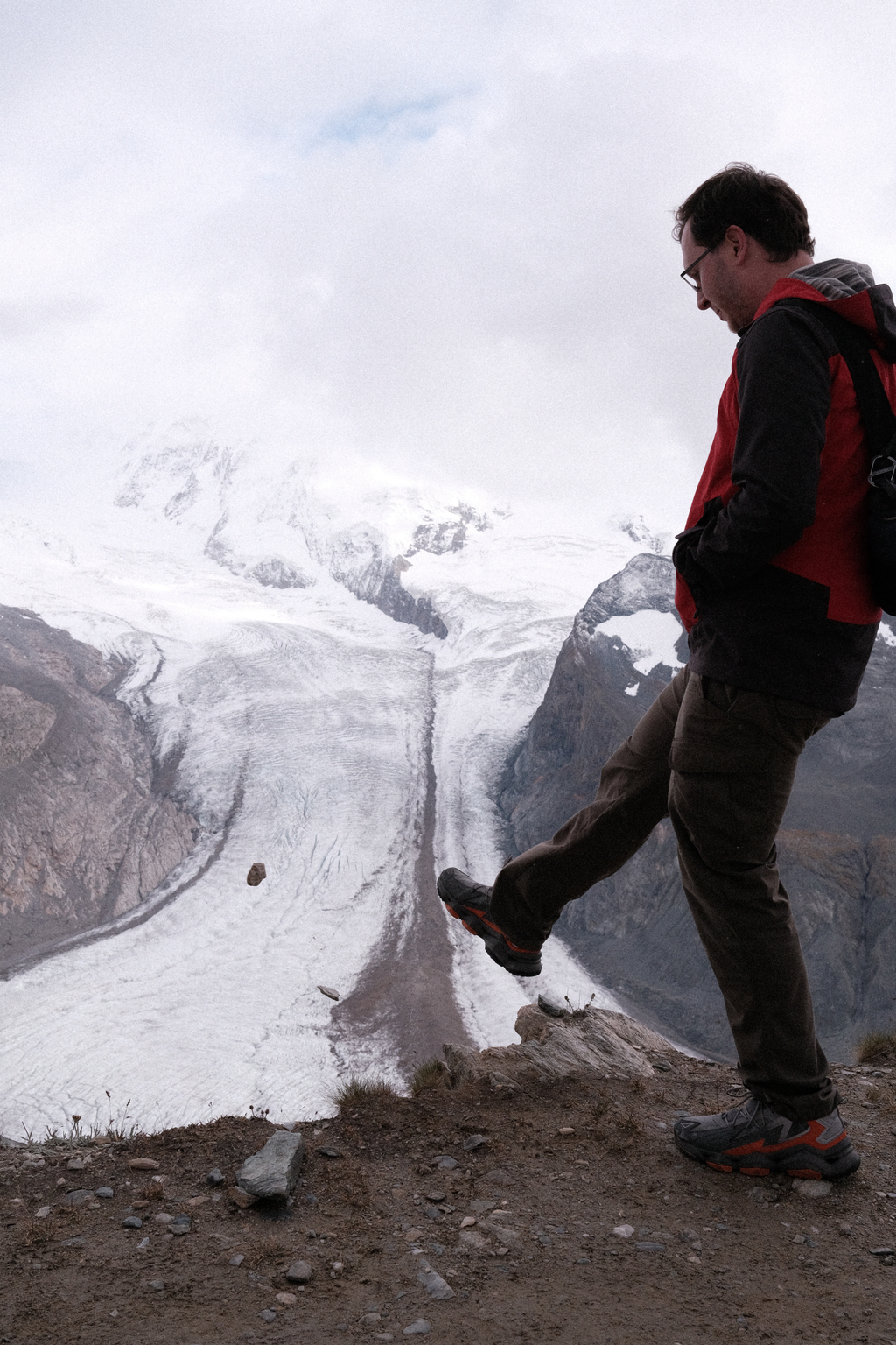 Nick kicking a rock off the step side of the mountain, towards Monte Rosa Glacier