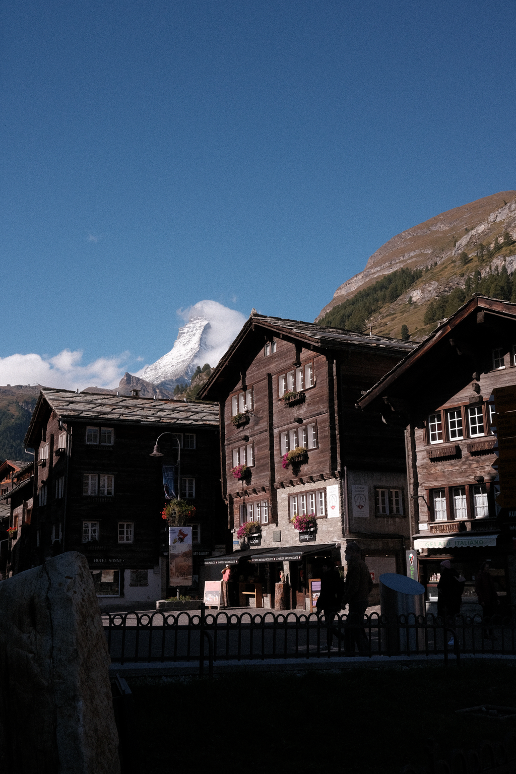 The Matterhorn behind a series of buildings in the morning light