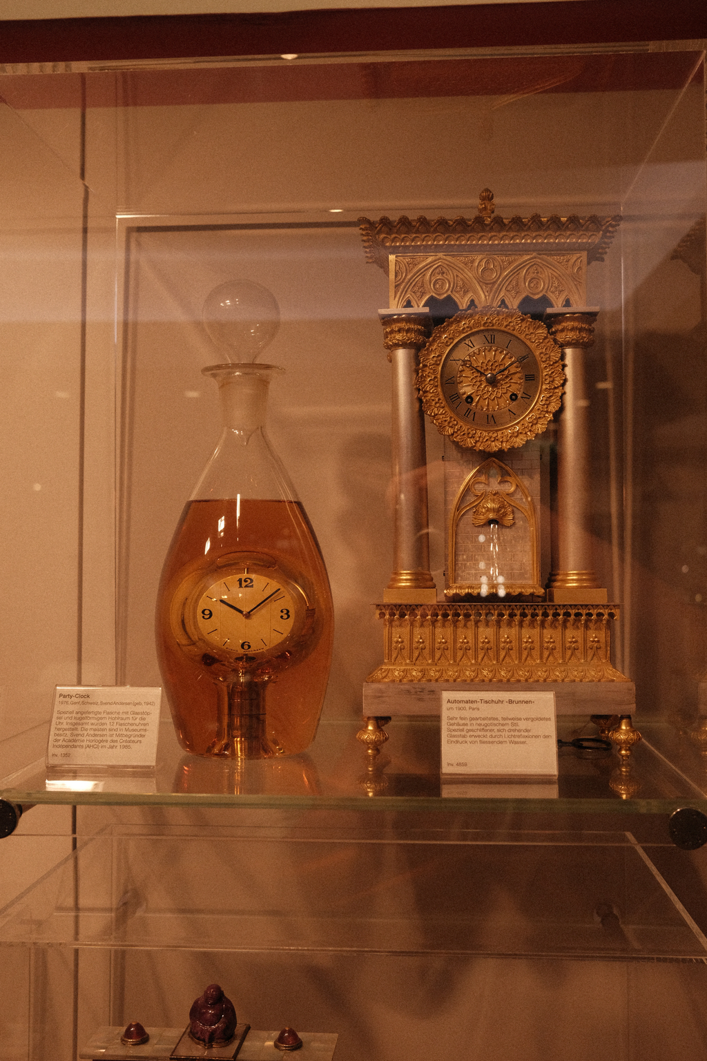 A clock designed to appear as though it's within a bottle of liquor