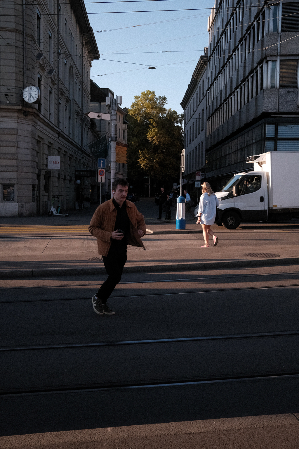 A man running across tram lines at the Central stop in Zurich