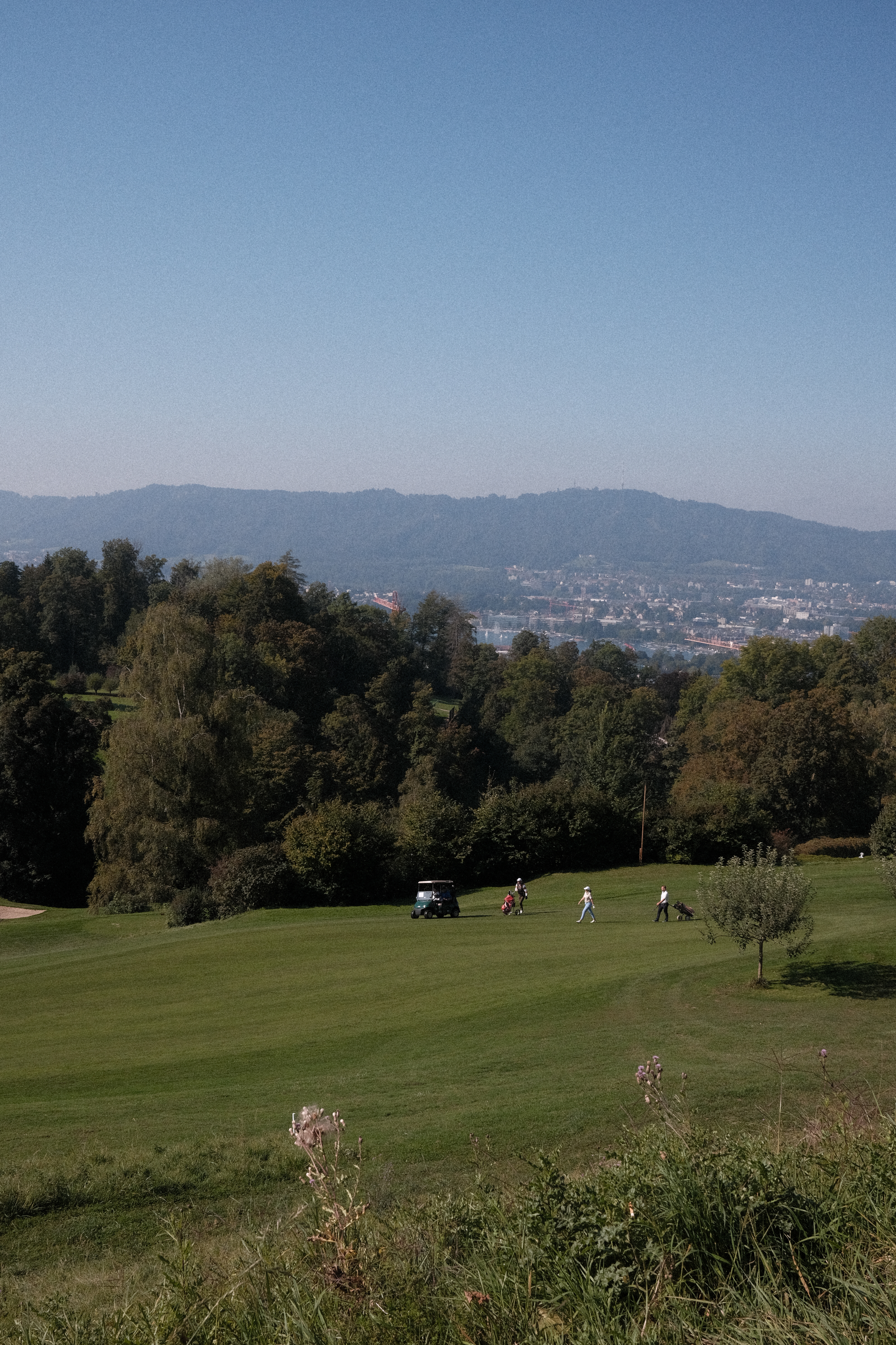 A group of players crossing a golf course