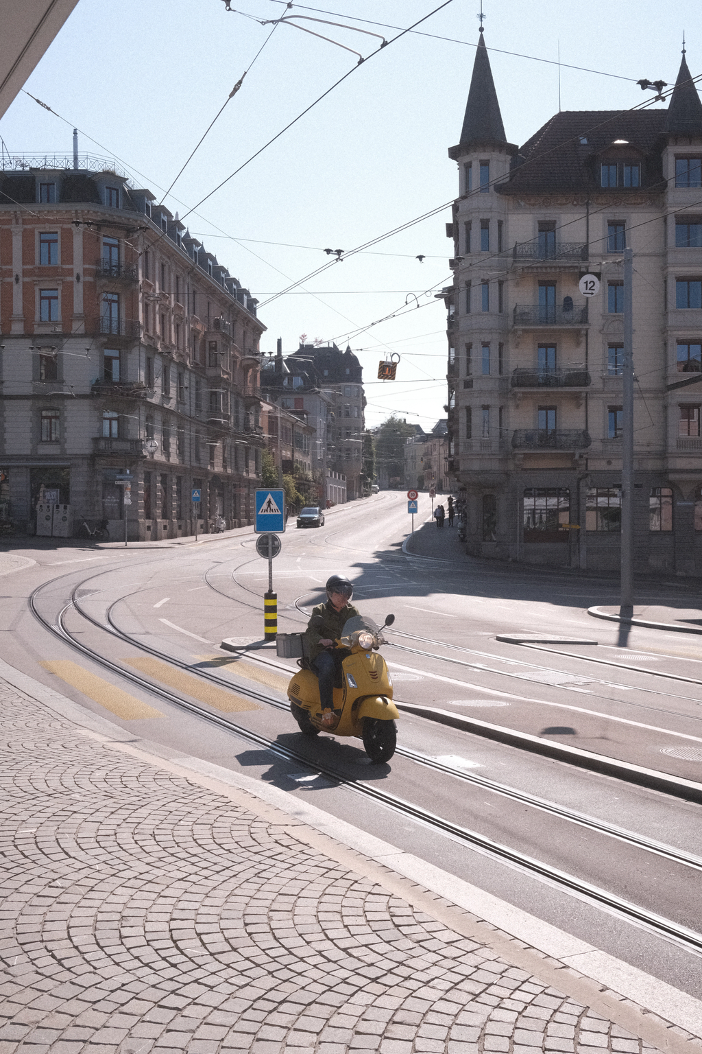 A vespa passing by at the Römerhof tram stop