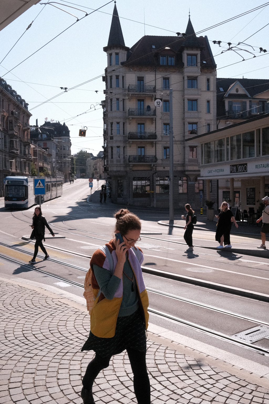 Pedestrians navigating the Römerhof tram stop