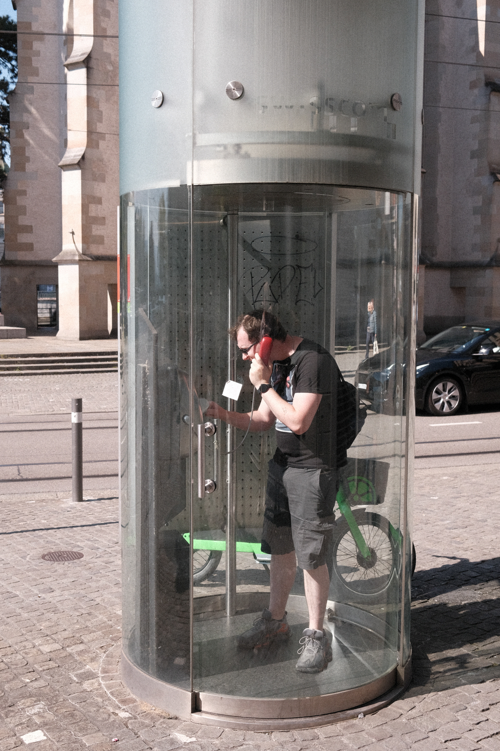 Nick using a Swiss phone booth