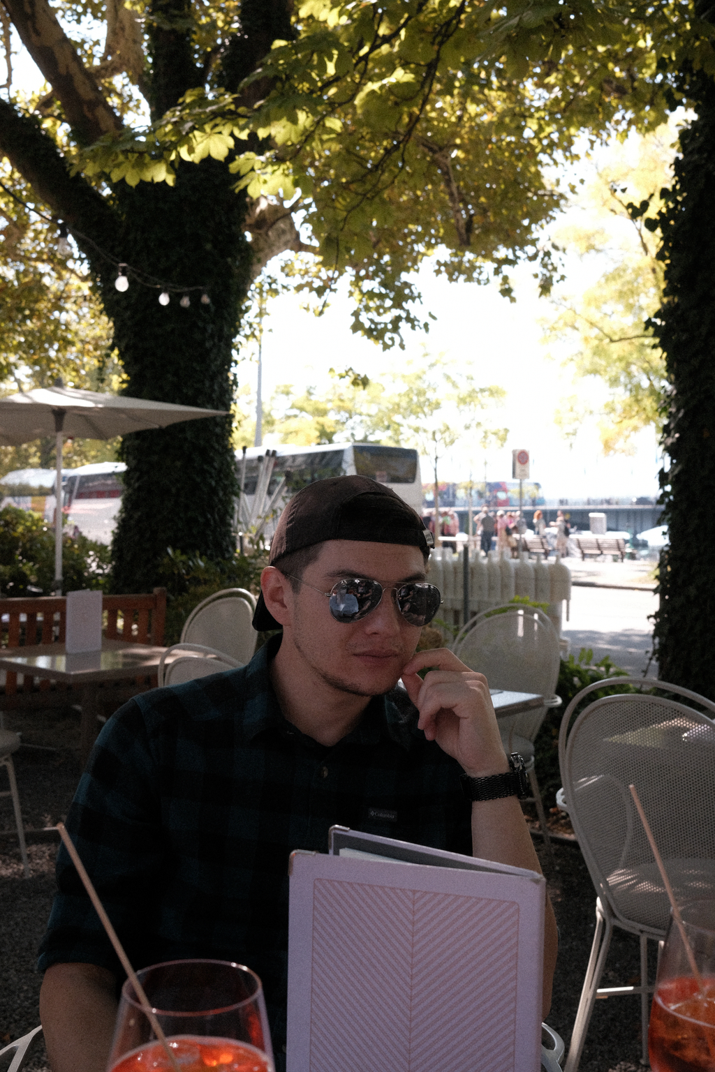 Tim sitting in a garden plaza with Aperol Spritzes