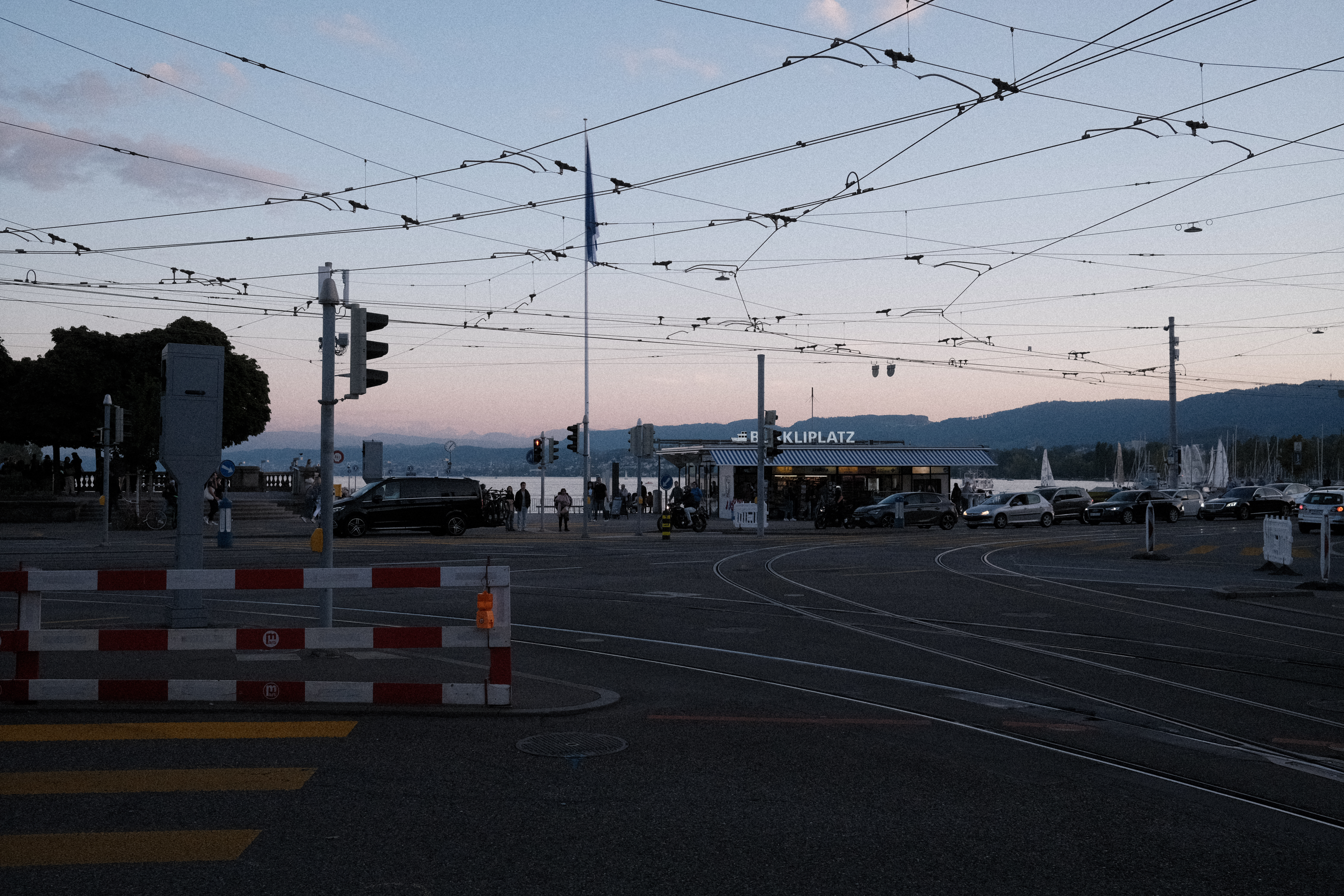 Sunset filtered through the overhead cables for trams and busses at Bürkliplatz