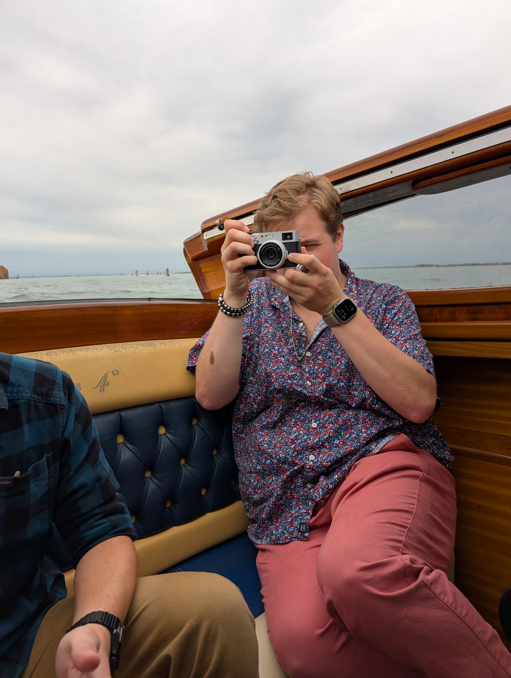 Sean in the boat coming back from the glass factory, taking a picture