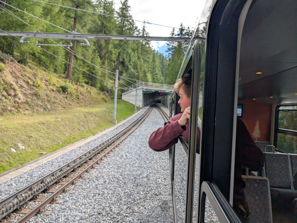 Sean leaning out of a window of the Gornergrat railway