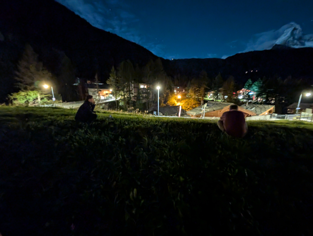 Sean & Tim sitting in a field taking long-exposure shots of the Matterhorn